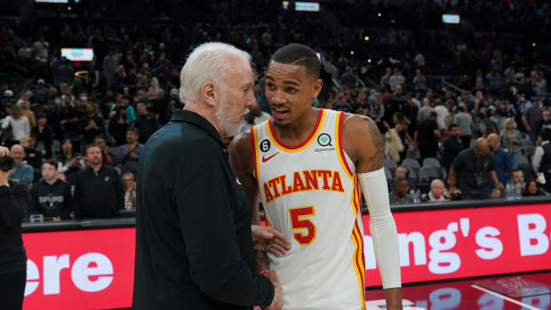 Mar 19, 2023; San Antonio, Texas, USA; San Antonio Spurs head coach Gregg Popovich talks with Atlanta Hawks guard Dejounte Murray (5) after the game at the AT&T Center.